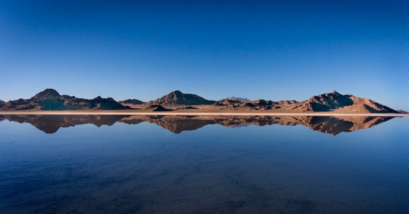Mountain reflections on the water covering the Bonneville Salt Flats.
